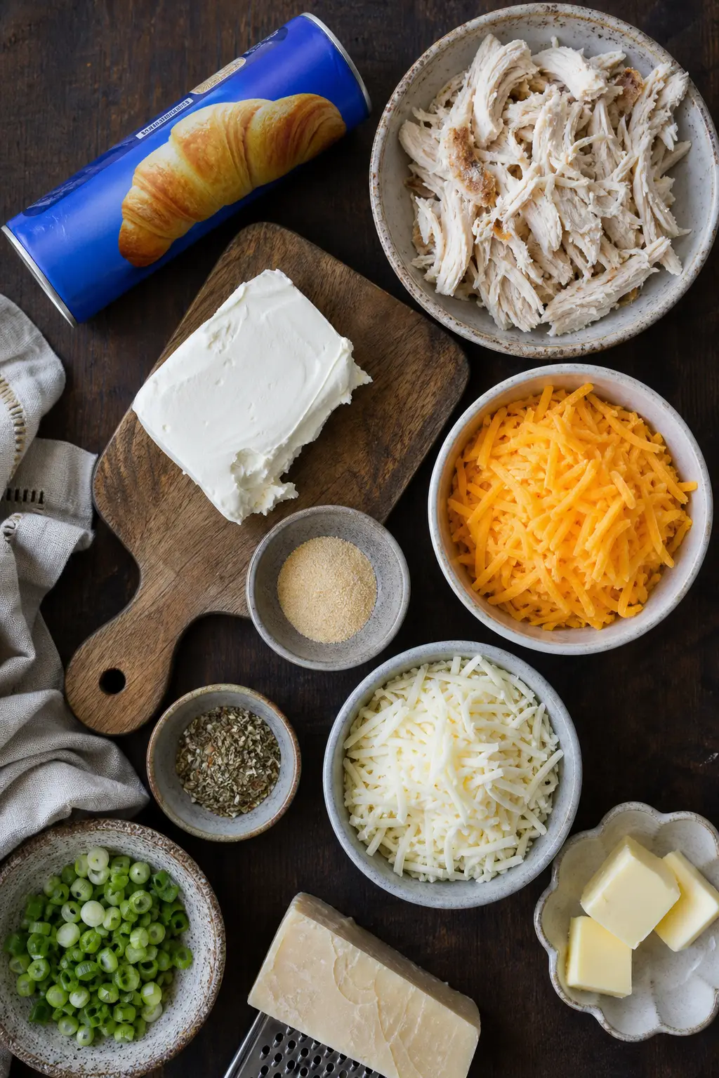 cheesy chicken stuffed croissant ingredients flat lay on dark surface